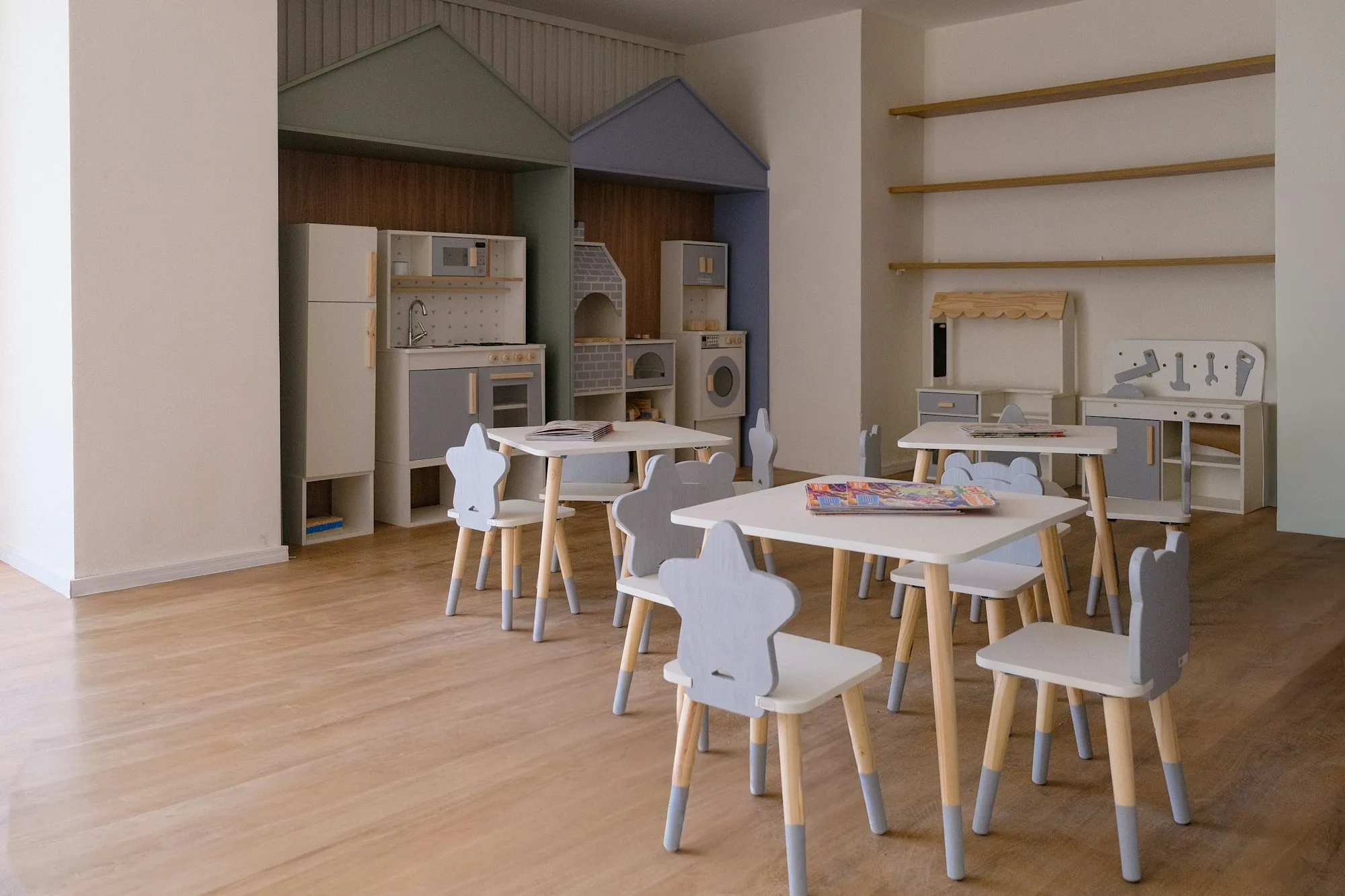 Child care playroom with child-sized tables and storage