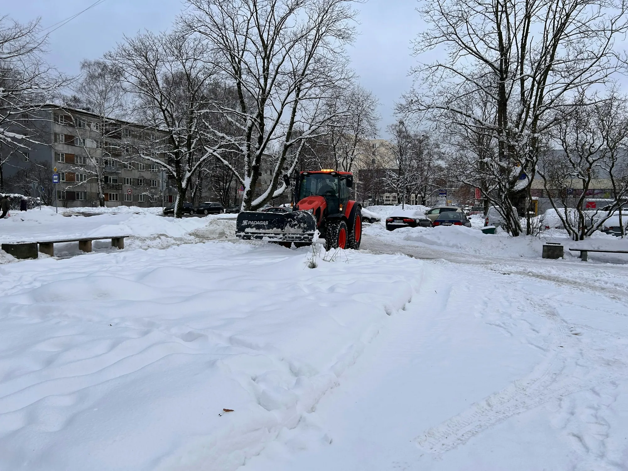 Snow plow clearing a commercial lot