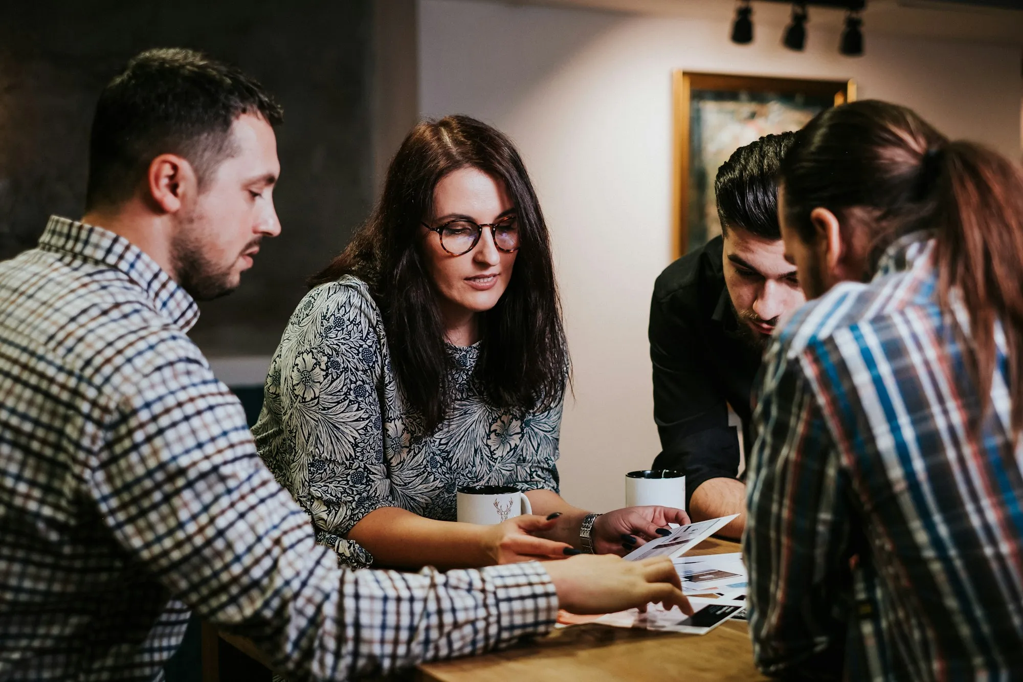 Team reviewing documents around a table