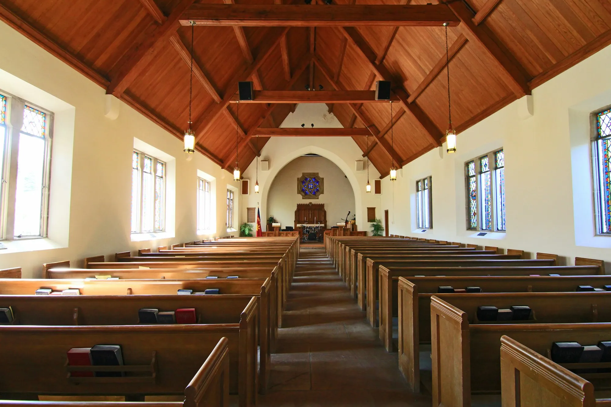Interior of a place of worship with wooden pews